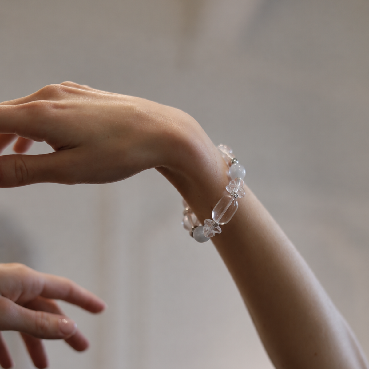 Clear quartz and white moonstone bracelet worn on wrist