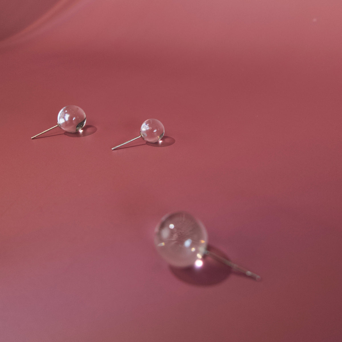 Close-up of transparent clear quartz sphere earrings and sterling silver posts