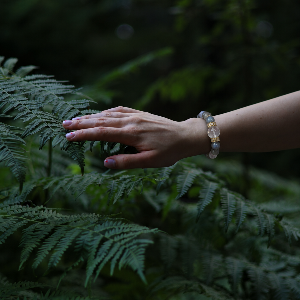 Grey moonstone crystal bracelet worn on wrist